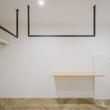 全体的に白くまとめつつも、バスルームのドアや室内物干しのアイアンバーをブラックにすることで空間を引き締めます。床はパーケット張りでアクセントをプラス。